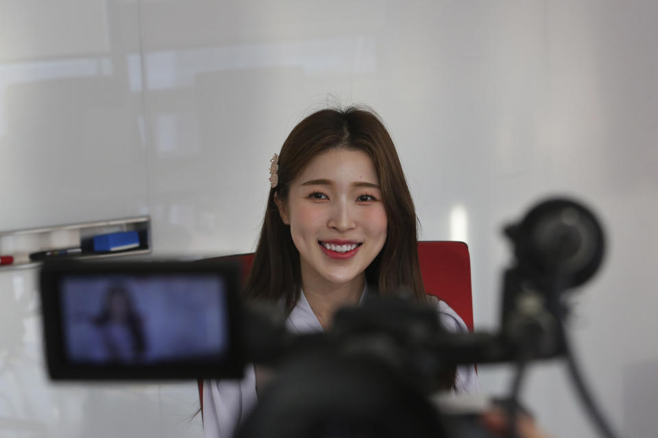 In this Thursday, Feb. 20, 2020, photo, Kang Na-ra, a Youtuber who defected in 2014, smiles during an interview in Seoul, South Korea. South Korea's latest hit drama "Crash landing on you" portrays the fantastical story of a billionaire heiress accidentally paragliding into North Korea and falling in love with army captain. The drama is a few reminders of Kang's faraway home. (AP Photo/Ahn Young-joon)