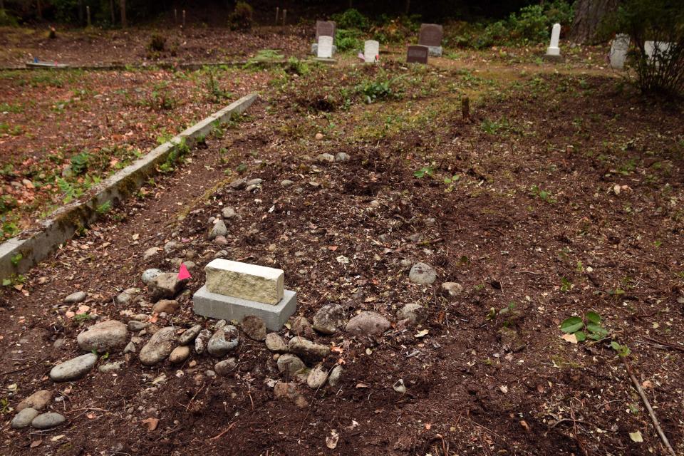 A sandstone block from Harrison Hospital marks an unknown grave recently identified by volunteers involved in the Seabeck Cemetery Restoration Project.