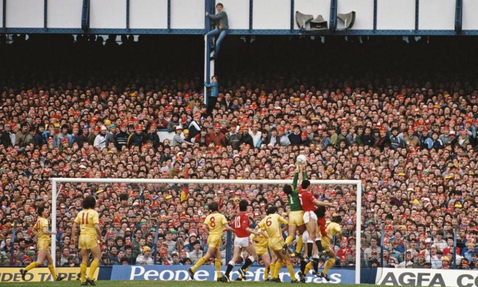 Two Liverpool fans climb up to get a better view of the action during the 1985 FA Cup semi final against Manchester United at Goodison Park