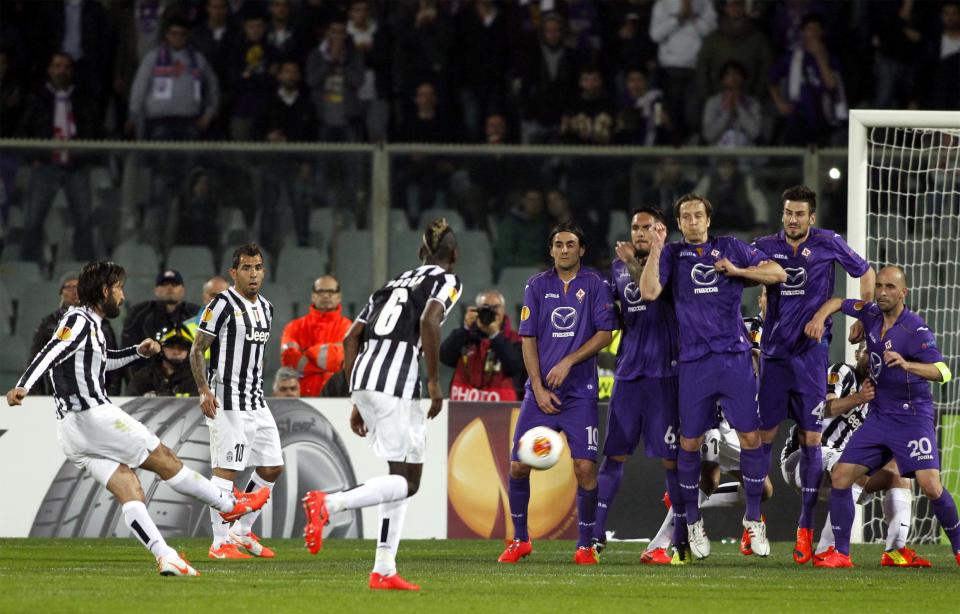 Juventus' Andrea Pirlo, left, scores during an Europa League, round of 16, return-leg soccer match between Fiorentina and Juventus, at the Artemio Franchi stadium in Florence, Italy, Thursday, March 20,, 2014. (AP Photo/Fabrizio Giovannozzi)