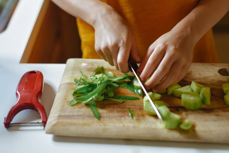 Teaching a teen the proper way to hold and use a knife is essential, says Miliotes. (Photo: Getty Creative)