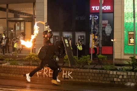 Demonstrator throws molotov cocktail at police during protest in Hong Kong