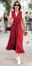 <p>We are loving Chung's fire engine red wrap dress, worn over a white tee and paired with white booties and a small black purse. </p>