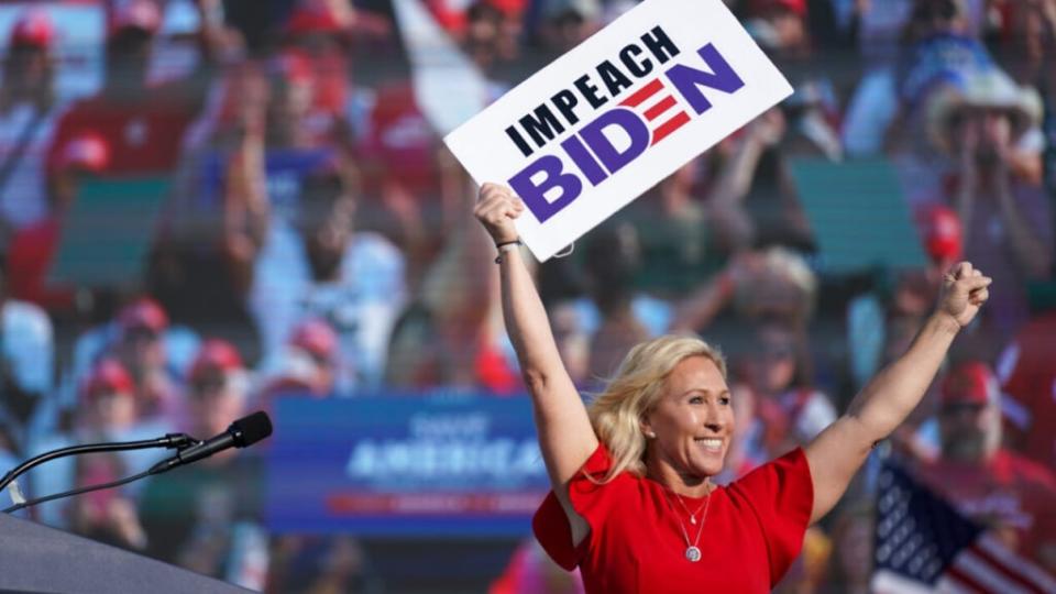 Rep. Marjorie Taylor Greene (R-GA) holds a sign that reads Impeach Biden at a rally featuring former US President Donald Trump on September 25, 2021 in Perry, Georgia. (Photo by Sean Rayford/Getty Images)