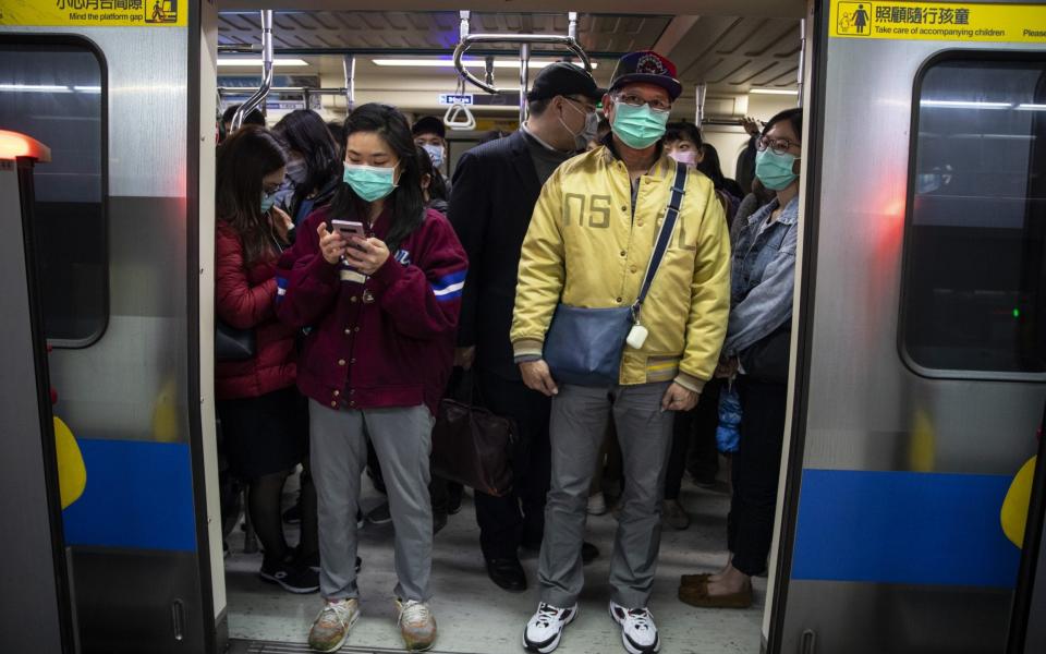 Commuters pack a metro train in downtownTaipei, Taiwan on March 18, 2020 in Taipei, Taiwan. Taiwan, Singapore and Hong Kong have had more successful approaches in battling the pandemic given their experience with SARS in 2003 - Paula Bronstein/Getty Images AsiaPac