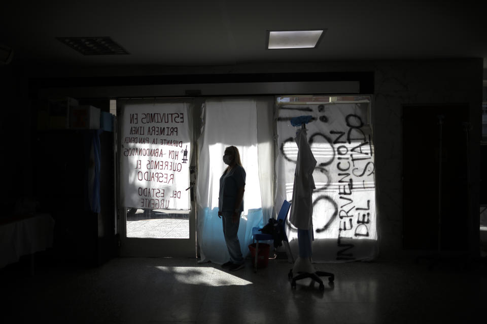 Nurse Lidia Del Valle stands inside San Andres Clinic which has been occupied by its former workers since it closed at the start of the year following the death of the hospital's director and owner in Caseros, Argentina, Friday, April 30, 2021. While the pandemic has swelled the need for hospital beds, many private clinics say they're struggling to survive, citing the pandemic having pushed away many non-COVID patients and losing money on coronavirus sufferers because the government insurance program doesn't pay enough to meet costs. (AP Photo/Natacha Pisarenko)