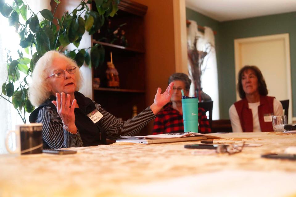 Randy Schnell, with fellow residents, discuss why they are opposed to a solar farm being built in their neighborhood and listed the track record of how these things go when the company is not longer observing the solar farm at one of the resident’s home on Friday, Jan. 26, 2024 in Millington, Tenn.