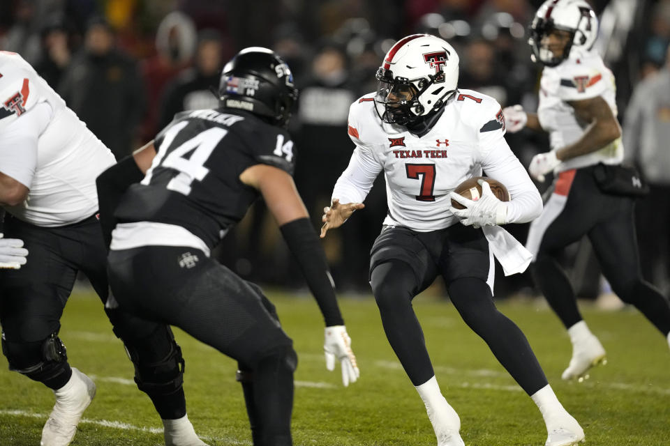 Texas Tech quarterback Donovan Smith (7) runs from Iowa State linebacker Carson Willich (14) during a 1-yard touchdown run in the first half of an NCAA college football game, Saturday, Nov. 19, 2022, in Ames, Iowa. (AP Photo/Charlie Neibergall)