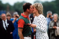 <p>Princess Diana and Prince Charles shared a kiss when she handed him a prize.</p>