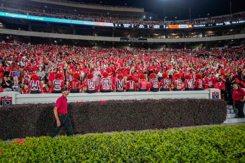 Georgia fans in the student section try to help recruit Arch Manning during the second half against South Carolina.