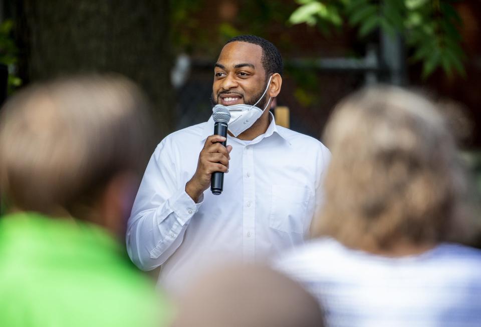 State Rep. Charles Booker smiles while speaking at a rally for Booker at Highland Coffee Company on Bardstown Road on Wednesday, June 17, 2020.