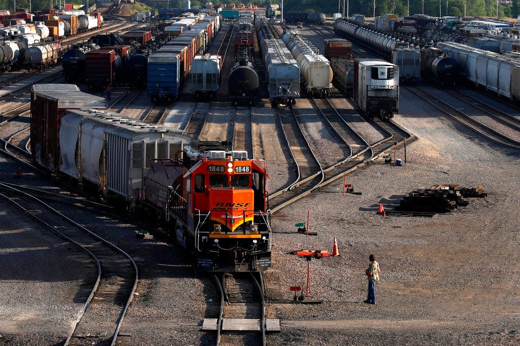 A BNSF rail terminal worker monitors the departure of a freight train Tuesday, June 15, 2021, in Galesburg. The terminal is the city's largest employer at about 1,300 workers and the second-largest rail yard for the nation's largest freight carrier. Galesburg handles 150 to 200 trains per day, sometimes eclipsing traffic at its main terminal near Kansas City, Missouri. (AP Photo/Shafkat Anowar)