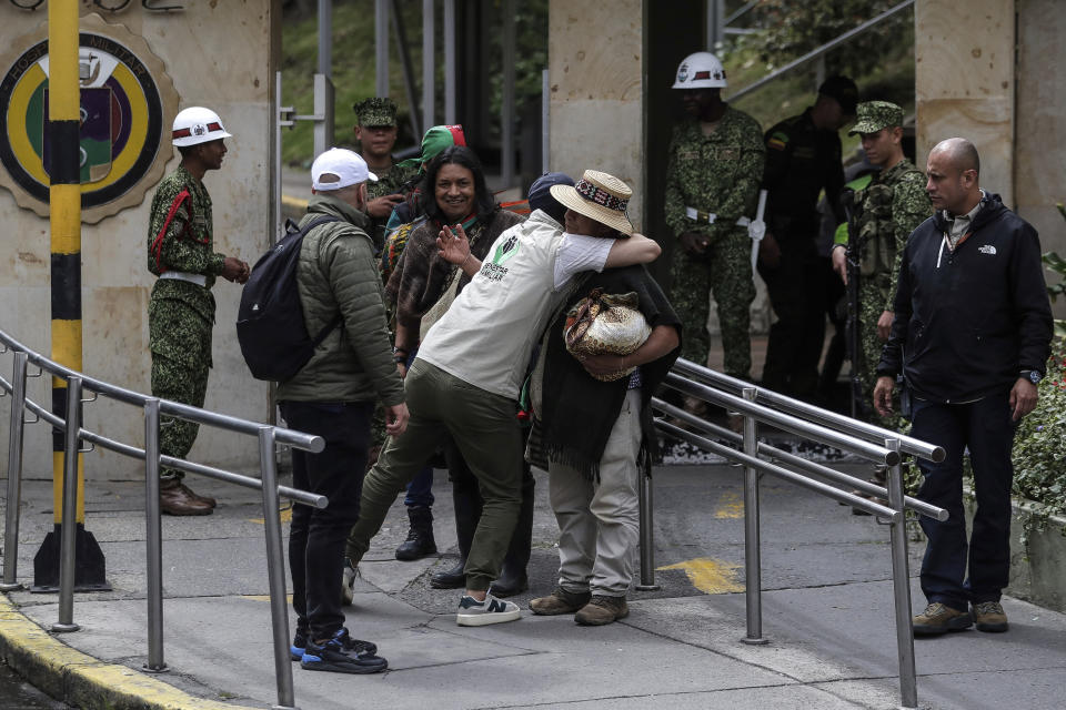 FILE - An Indigenous leader and a family welfare official embrace at the entrance of the military hospital where the four Indigenous children who survived an Amazon plane crash are receiving medical attention in Bogota, Colombia, Saturday, June 10, 2023. The crash killed three adults and the children braved the jungle for 40 days before being found alive. (AP Photo/Ivan Valencia, File)