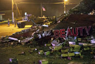 <p>Missouri National Guard stand watch in the background at the scene where a beauty salon was burned to the ground in the riots following Monday’s grand jury announcement, Nov. 26, 2014, in Ferguson, Mo. (AP Photo/David Goldman) </p>