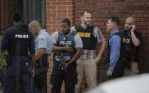 Members of various law enforcement agencies are pictured at the Washington Navy Yard campus in Washington, September 16, 2013. A gunman shot several people at the U.S. Navy Yard on Monday, with possible fatalities reported and the shooter being sought at the Naval Sea Systems Command headquarters, the Navy said. (REUTERS/Jason Reed)