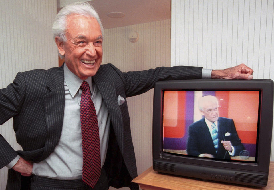FILE - Legendary game show host Bob Barker, 73, leans on his hotel room television showing his image, during an interview Monday, Oct. 23, 2000 in Cambridge, Mass. (AP Photo/Michael Dwyer, File)