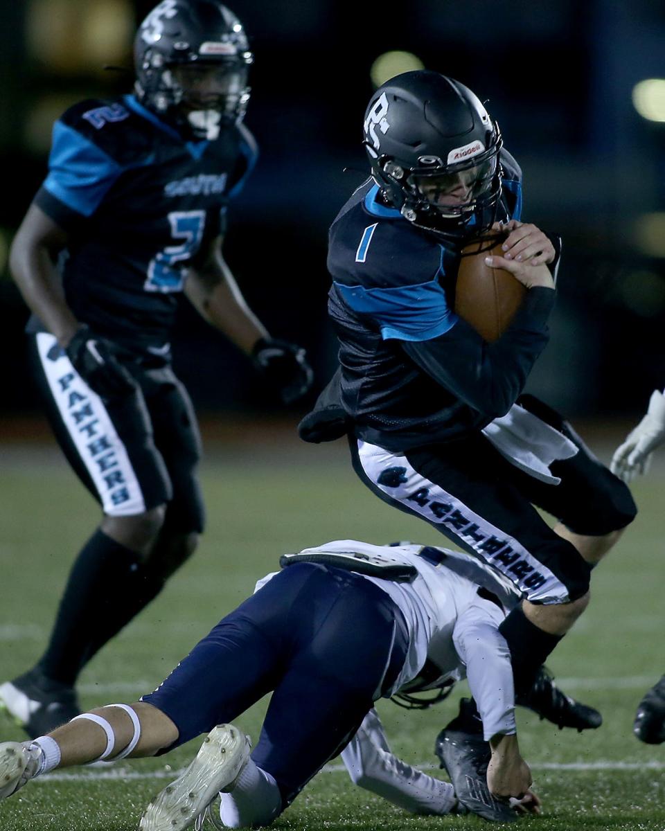 Plymouth South's Cole Brunstrom is brought down by Foxborough's Jaiden Jean on a quarterback keeper during first quarter action of their game against Foxborough at Plymouth South High on Friday, Sept. 23, 2022. Plymouth South would go on to win 21-14.