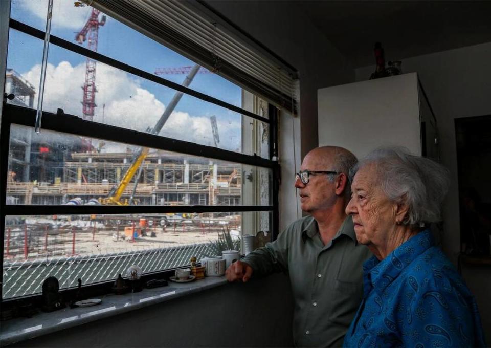 The construction of Plaza at Coral Gables is seen through the dining room window at the home of Orlando Capote, 63, and his mother, Lucia Capote, 90, in this 2019 Herald file photo. The family refused to sell to developers. AL DIAZ/adiaz@miamiherald.com