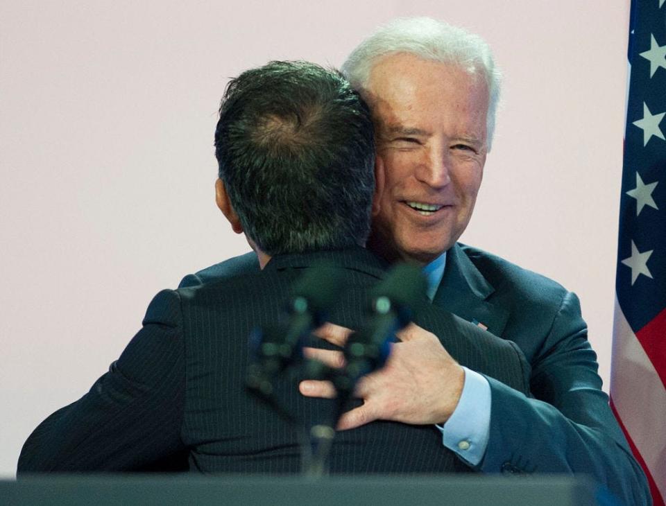 President Joe Biden giving Joe Kiani a hug