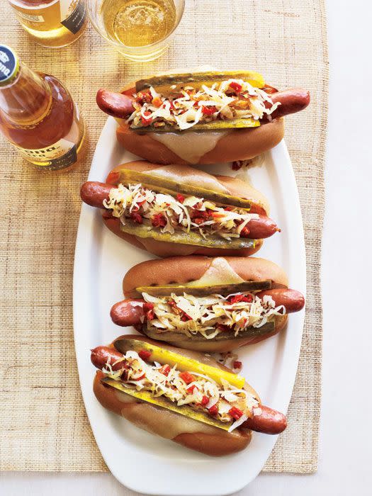 <p>Go ahead and pile on the toppings with these New-York-deli-inspired hot dogs. Or swap corned beef for wieners for a completely fresh take. </p><p><em><a href="https://www.goodhousekeeping.com/food-recipes/a11012/grilled-reuben-dogs-recipe-rbk0611/" rel="nofollow noopener" target="_blank" data-ylk="slk:Get the recipe for Grilled Reuben Dogs »;elm:context_link;itc:0;sec:content-canvas" class="link ">Get the recipe for Grilled Reuben Dogs »</a></em> </p>