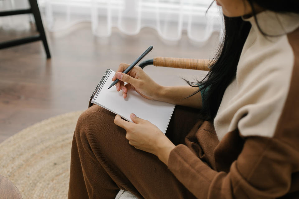 a woman writing in a notebook