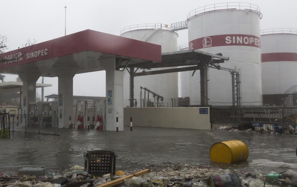 <p>Oil drums and floating trash are seen at a flooded Sinpoec gas station during the passage of Super Typhoon Mangkhut near Heng Fa Chuen housing estate in Hong Kong, China, on Sept. 16, 2018.<br>The Hong Kong government hoisted the T10 signal which is the highest and most severe hurricane warning in Hong Kong.<br>(Photo by Alex Hofford, EPA) </p>