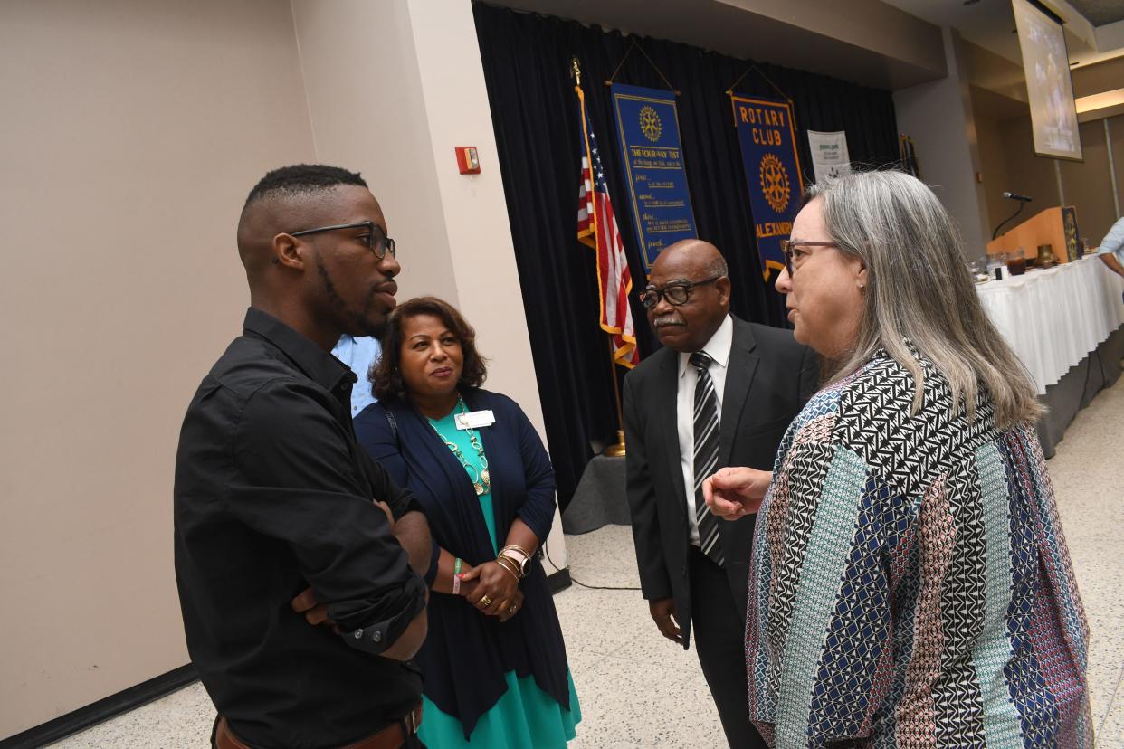 Clark Burnett (left), an associate producer with acclaimed filmmaker Ken Burns' production company, Florentine Films, talks with Catherine M. Pears (far right), Dr. Haywood Joiner and Connie Cooper at the Rotary Club of Alexandria's Tuesday luncheon. Florentine Films is working on a film project that will feature J.B. Lafargue, founder of Peabody High School and an advocate for the Black community.