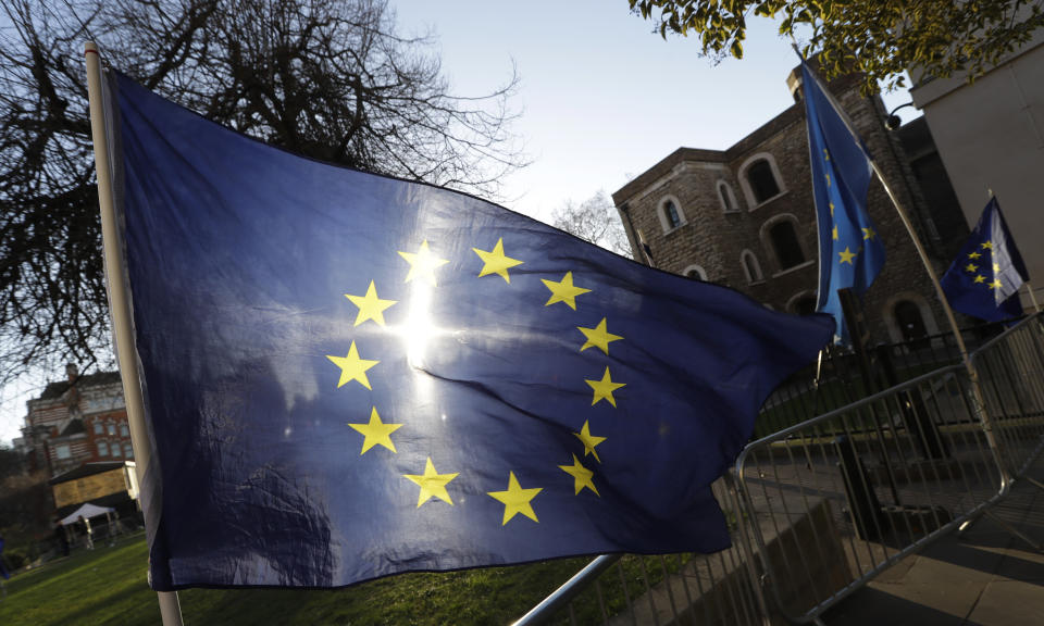 The sun shines through a European Union flag tied onto a railing near parliament in London, Thursday, Jan. 17, 2019. British Prime Minister Theresa May is reaching out to opposition parties and other lawmakers Thursday in a battle to put Brexit back on track after surviving a no-confidence vote. (AP Photo/Kirsty Wigglesworth)