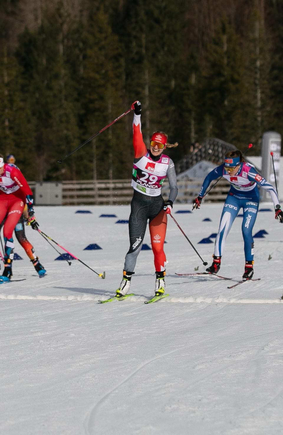 Whitehorse skier Sonjaa Schmidt raises her arm in victory as she cross the finish line in the U23 women's sprint event at the Nordic World Ski Championships in Slovenia, Feb. 6, 2024.