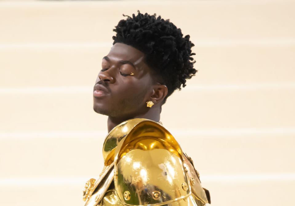 I could write a whole dissertation on Lil Nas X's — not one, not two, but three — looks, but it's the simple detailing on his eye that I want to focus on here. The small gold wing and earrings are the perfect accent for all of his costume changes. The A+ here stands for 