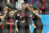 Leverkusen's Patrik Schick, center, celebrates after scoring the decisive goal during the German Bundesliga soccer match between Bayer Leverkusen and TSG Hoffenheim at the BayArena in Leverkusen, Germany, Saturday, March 30, 2024. (AP Photo/Martin Meissner)