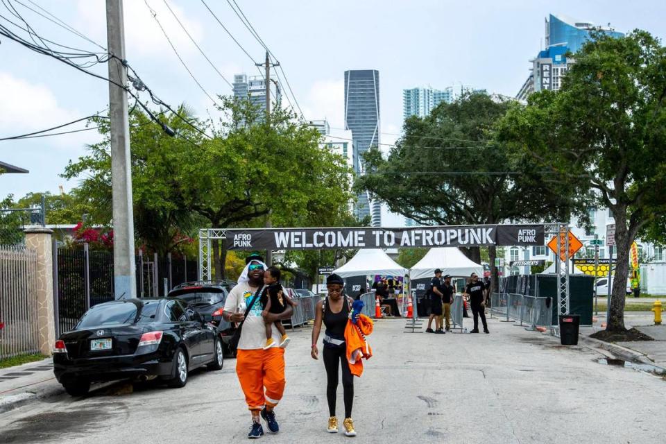 Orlando natives Marvin Allen, 30, holding his son Raylen Allen-Moss, 1, and his wife Jasmine Allen, 33, take a break from the heat during AFROPUNK music festival at The Urban in the Historic Overtown neighborhood of Miami, Florida, on Saturday, May 21, 2022.