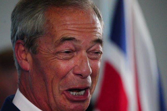 Nigel Farage speaking in front of a Union flag