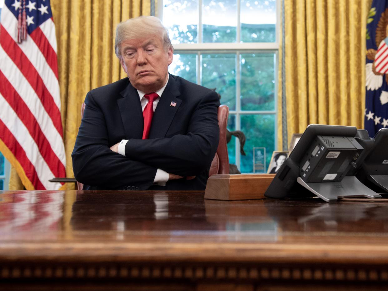 <p>US President Donald Trump sits at the Resolute Desk during a briefing on Hurricane Michael in the Oval Office of the White House in Washington, DC, on 10 October 2018</p> ((AFP via Getty Images))