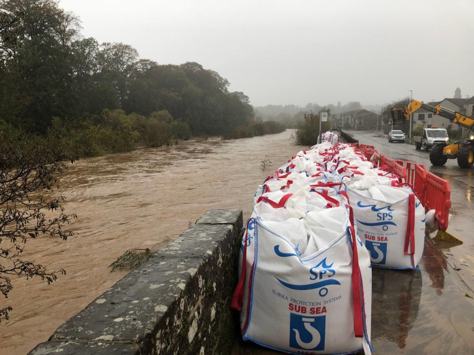 Sandbags were pictured alongside a collapsed river wall on River Street in Brechin on Saturday (PA)