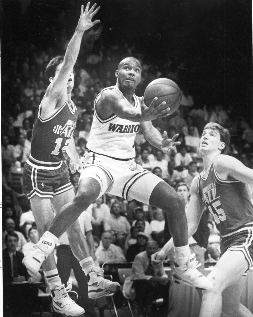 10/13/89 Golden State guard Tim Hardaway soars between Utah defenders John Stockton, left, and Eric Leckner. Hardaway faced Leckner in college - Leckner played for Wyoming.