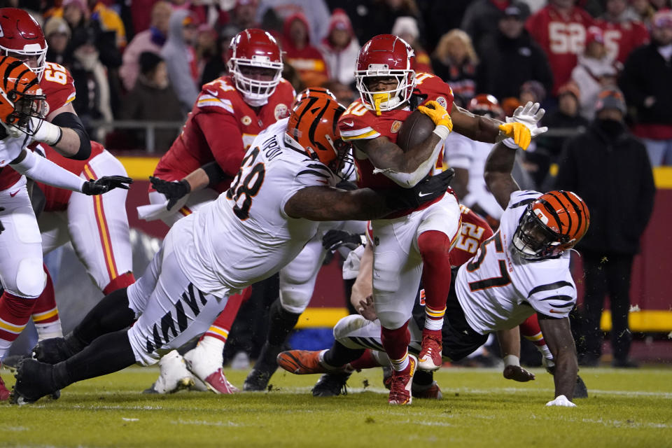 Kansas City Chiefs running back Isiah Pacheco (10) runs with the ball as Cincinnati Bengals defensive tackle Josh Tupou (68) defends during the second half of an NFL football game Sunday, Dec. 31, 2023, in Kansas City, Mo. (AP Photo/Ed Zurga)