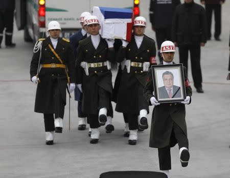 Flag-wrapped coffin of late Russian Ambassador to Turkey Andrei Karlov is carried to a plane during a ceremony at Esenboga airport in Ankara, Turkey, December 20, 2016. REUTERS/Umit Bektas