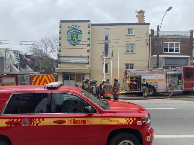 Toronto fire vehicles and firefighters are pictured here at the scene of what later became a fatal fire on Wednesday. (Grant Linton/CBC - image credit)