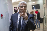 REPLACES COMMON GOOD INSTEAD OF COMMON GROUND - Israeli opposition leader Yair Lapid, arrives for a news conference in Tel Aviv, Thursday, May. 6, 2021. Lapid called on his potential partners to find "common good" and expressed optimism that a new coalition government would be formed. (AP Photo/Oded Balilty)