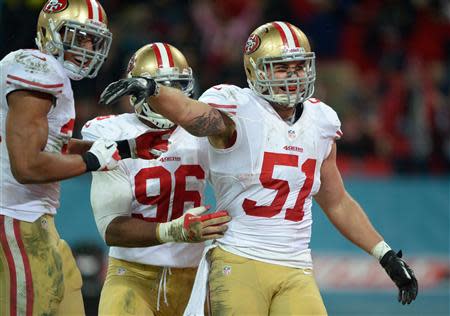 San Francisco 49ers outside linebacker Dan Skuta (51) celebrates with teammates including Corey Lemonier (96) after scoring a touchdown on a fumble recovery return against the Jacksonville Jaguars in the second half during an International Series game at Wembley Stadium. Mandatory Credit: Bob Martin-USA TODAY Sports