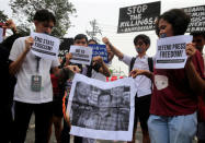 Members of the College Editors Guild of the Philippines hold placards while burning a picture of President Rodrigo Duterte during a protest outside the presidential palace in Metro Manila, Philippines January 17, 2018. REUTERS/Romeo Ranoco