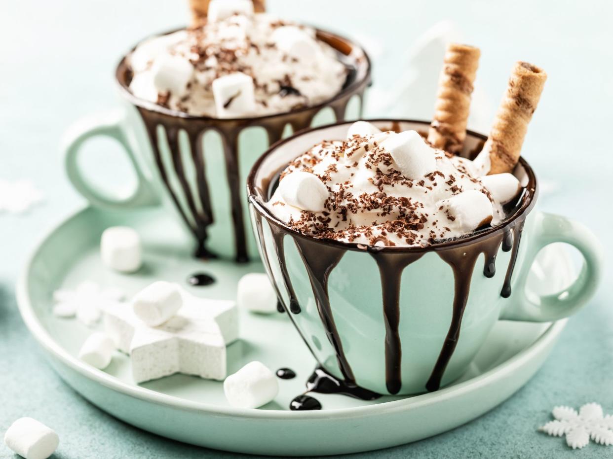 Hot chocolate or eggnog. Festive dessert with whipped cream or ice cream and chocolate
