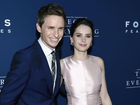 Cast members Eddie Redmayne (L) and Felicity Jones pose during "The Theory of Everything" premiere in Beverly Hills, California October 28, 2014. REUTERS/Kevork Djansezian