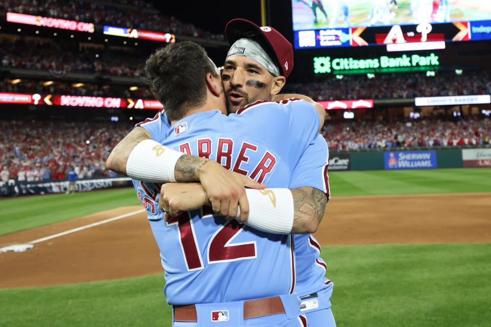 Kyle Schwarber and Nick Castellanos celebrate on the field after Game 4 in Philadelphia.