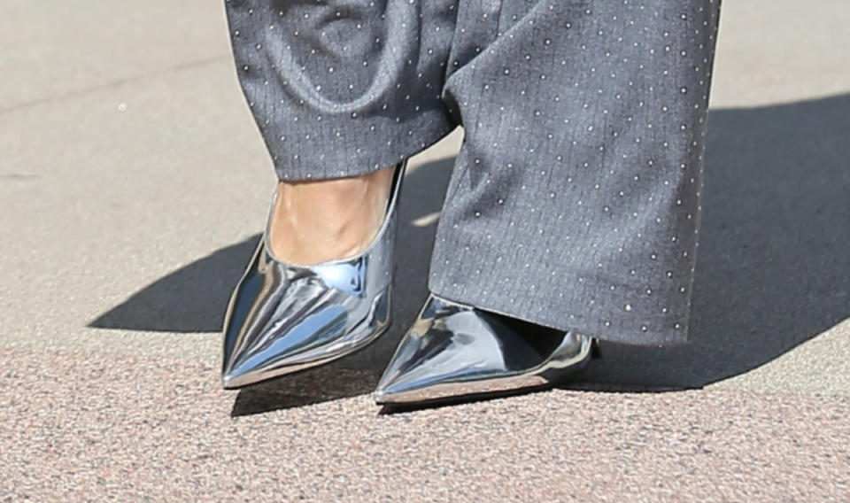 Heidi Klum wearing silver metallic heels