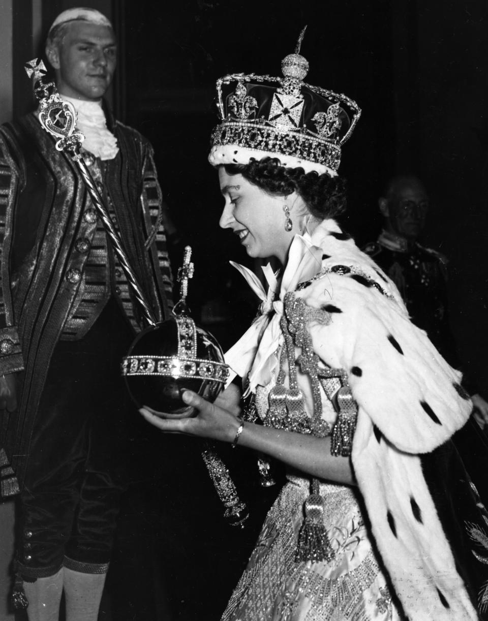 The Queen wearing the Imperial state Crown and carrying the Orb and sceptre after the coronation. (Getty Images)