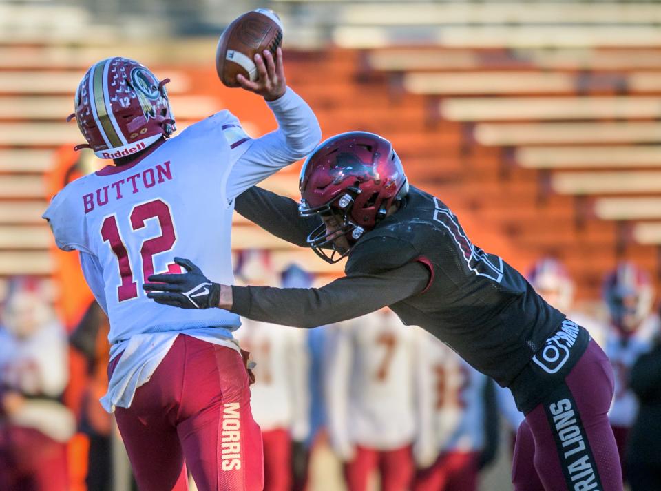 Peoria High's Rontavis Lee, right, puts a hit on Morris quarterback Carter Button during their Class 5A football state semifinal Saturday, Nov. 19, 2022 at Peoria Stadium.