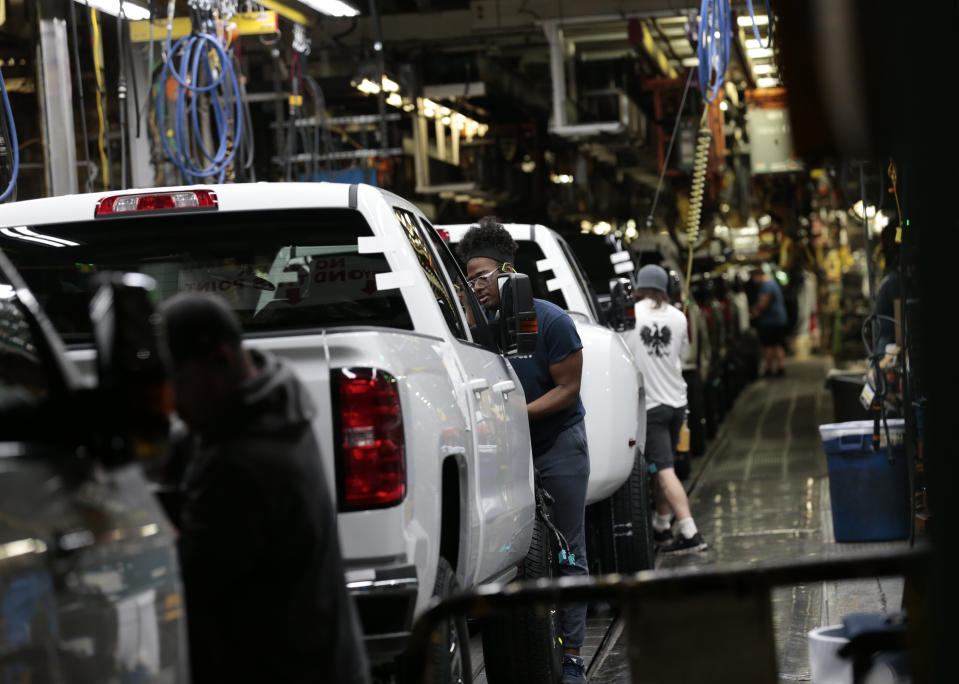 Workers inspect General Motors Co. (GM) Chevrolet 2019 Silverado HD and 2019 GMC Sierra HD pickup trucks on the assembly line at the GM plant in Flint, Michigan, U.S., on Tuesday, Feb. 5, 2019. GM is selling lots of expensive pickup trucks and sport utility vehicles in the U.S., which helped its average vehicle sales price hit a record $36,000. That played a big role in the better-than-expected quarterly earnings. Photographer: Jeff Kowalsky/Bloomberg via Getty Images 