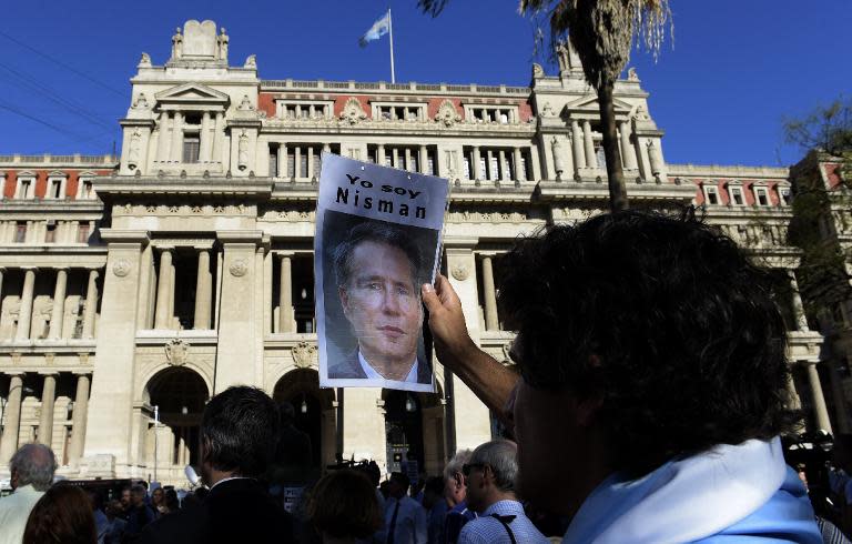 A man holds a portrait of late Argentine prosecutor Alberto Nisman during a demonstration in demand of justice, in front of the law court in Buenos Aires on March 18, 2015